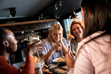 Group of young female friends having fun in restaurant, talking