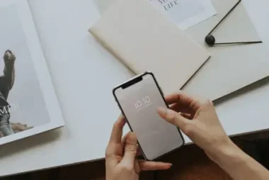 iphone with magazines and desk behind